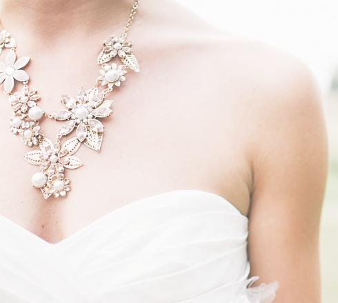 Yellow gold floral statement drop necklace set with white pearls and diamonds.