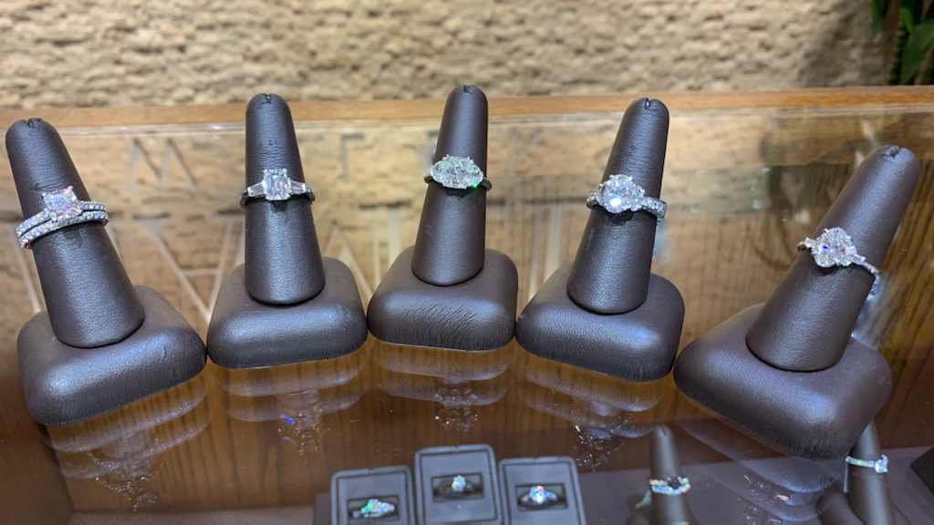 Five styles of white gold diamond engagement rings on display in the Leo Hamel Fine Jewelers showroom.