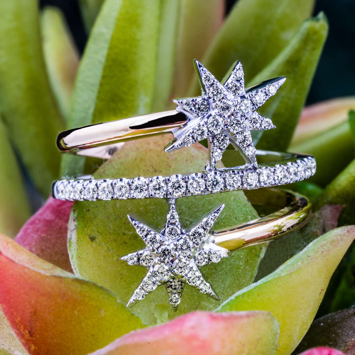 Yellow gold three-row open starburst ring set with diamonds.