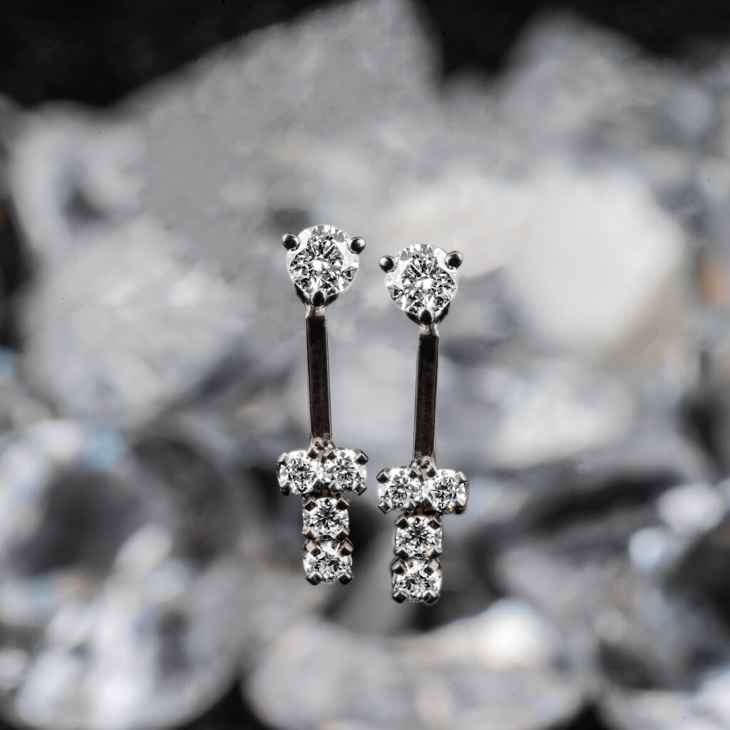 White gold drop earrings set with diamonds.