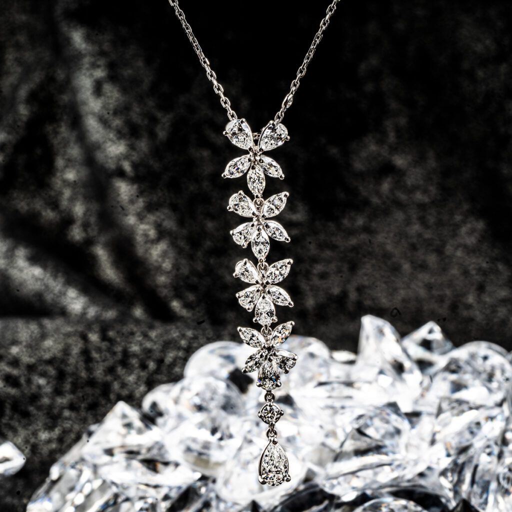 White gold floral drop necklace set with diamonds.
