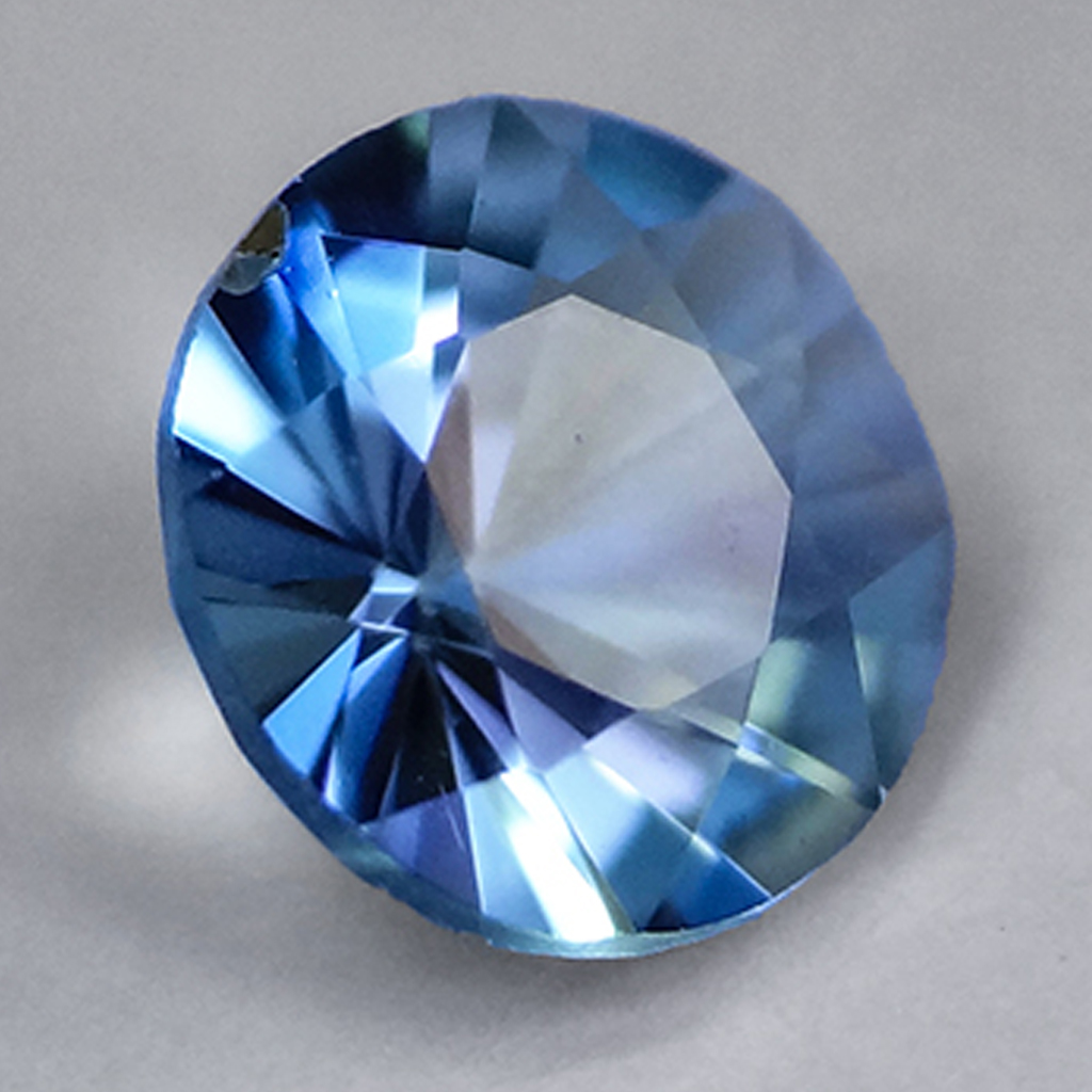 Loose round cut grandidierite gemstone.