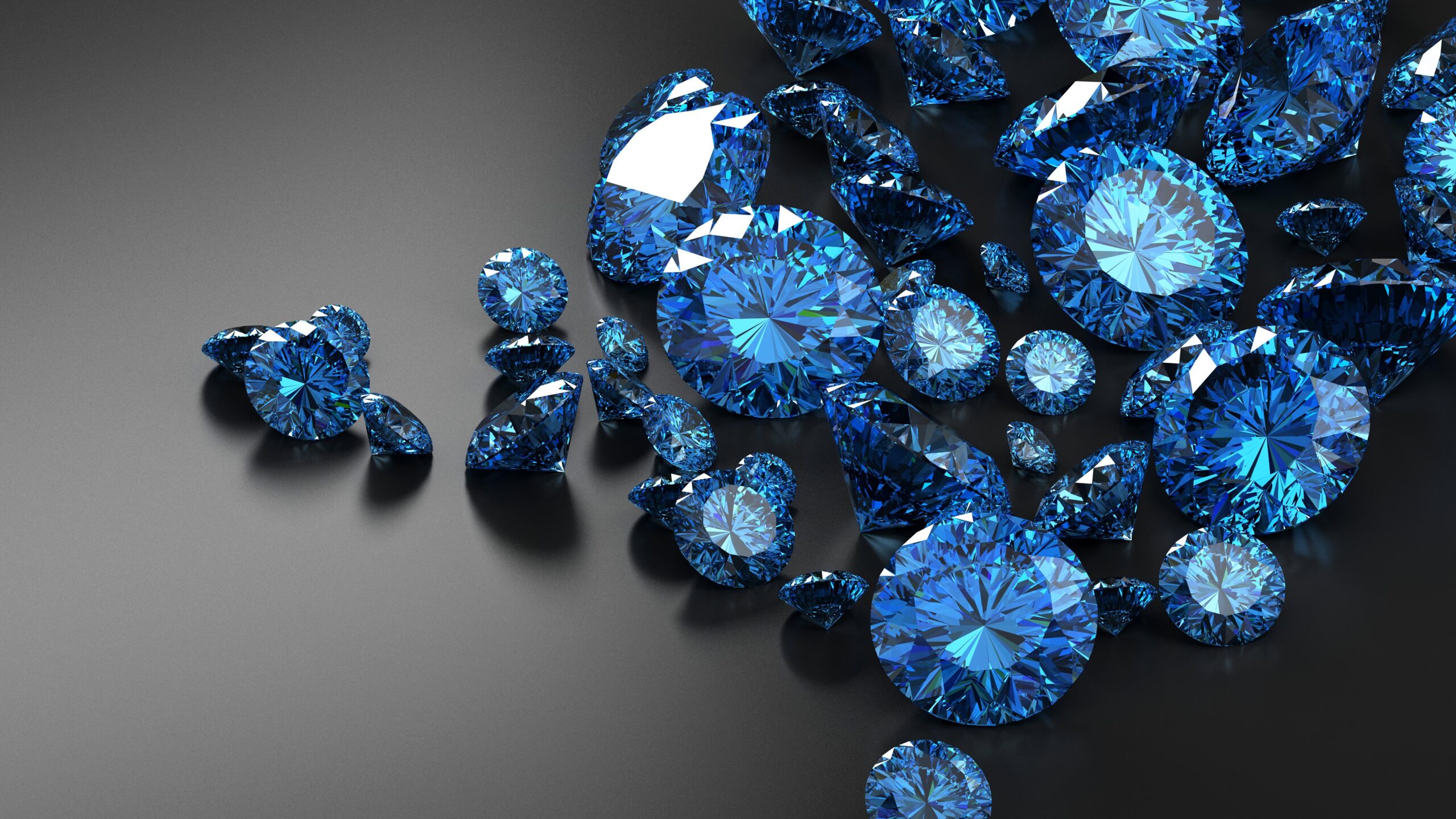 Pile of loose cut blue gemstones.