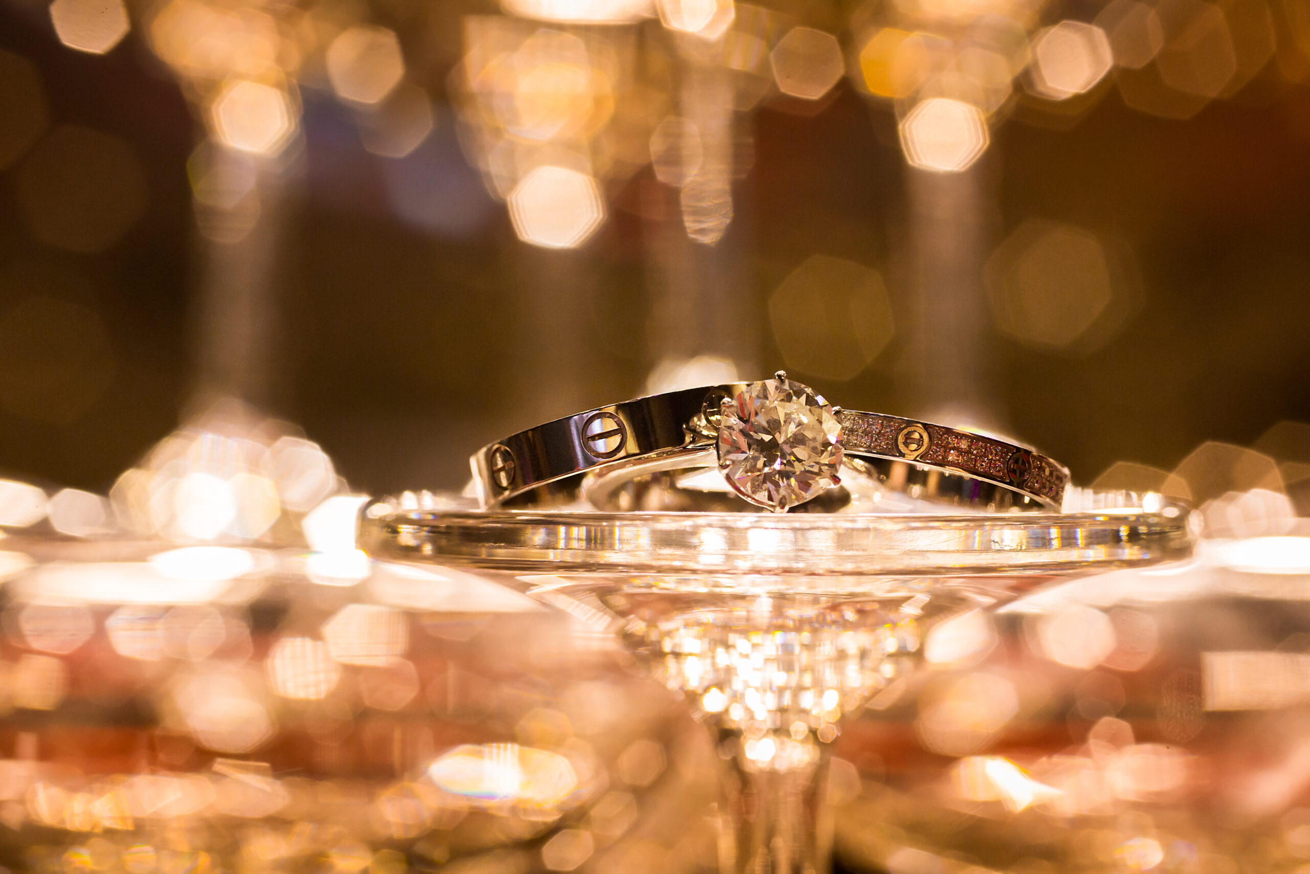 Cartier LOVE ring and bracelet displayed on glass
