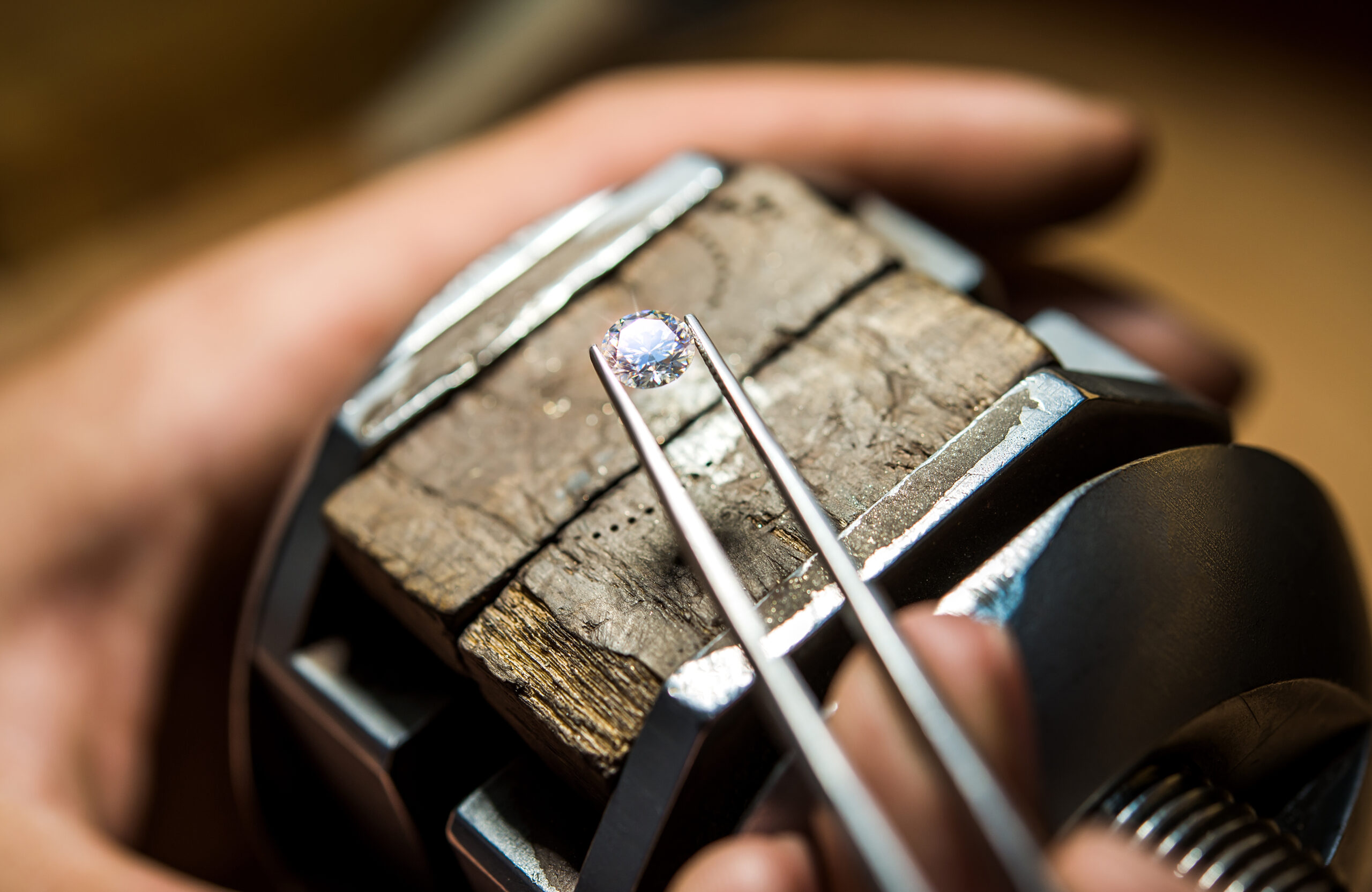Jeweler Starting Work on Loose Diamond with Tweezers