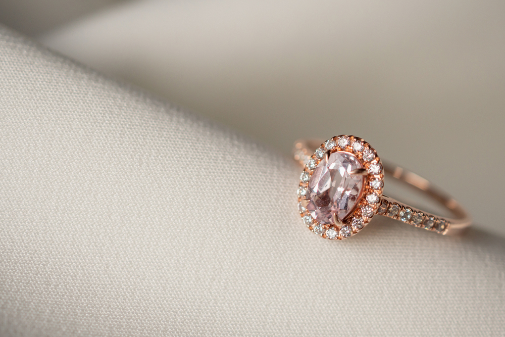 - Leo Hamel - Leo Hamel Rose gold engagement ring centered with a pink diamond surrounded by a white diamond halo and white diamonds in the band.