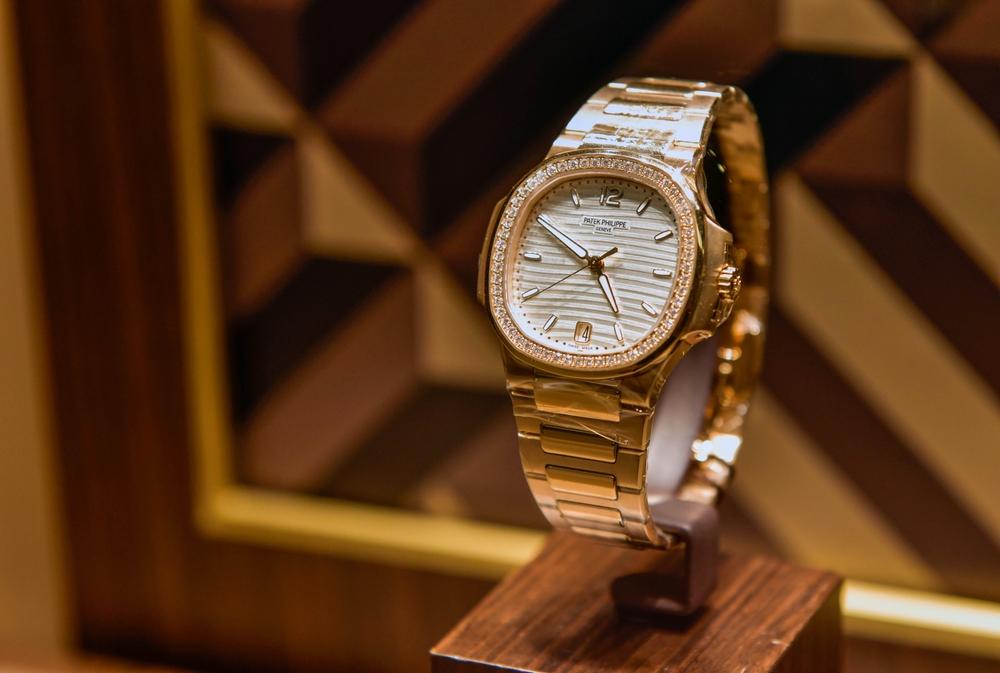 Women's yellow gold Patek Philippe with white dial on display.