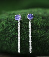 White gold drop earrings set with tanzanite and diamonds.