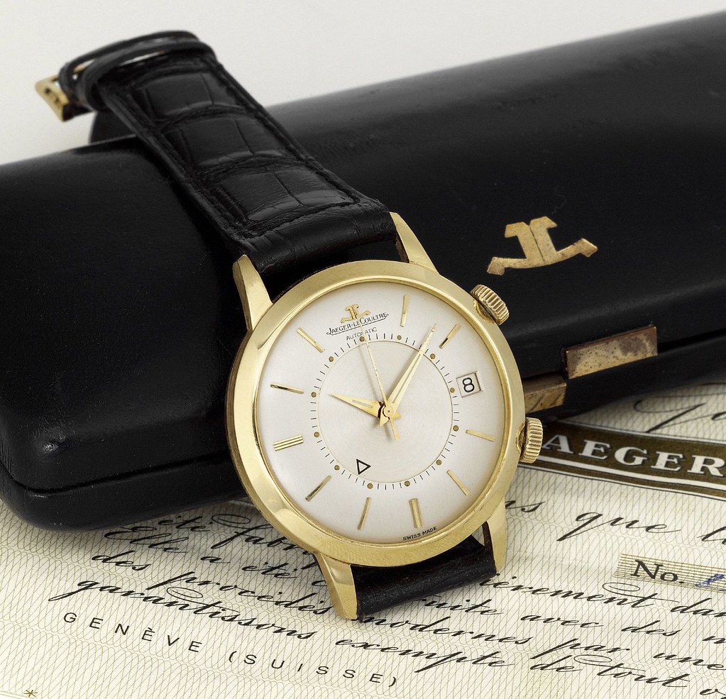 Yellow gold Jaeger-LeCoultre with white dial and black leather strap.