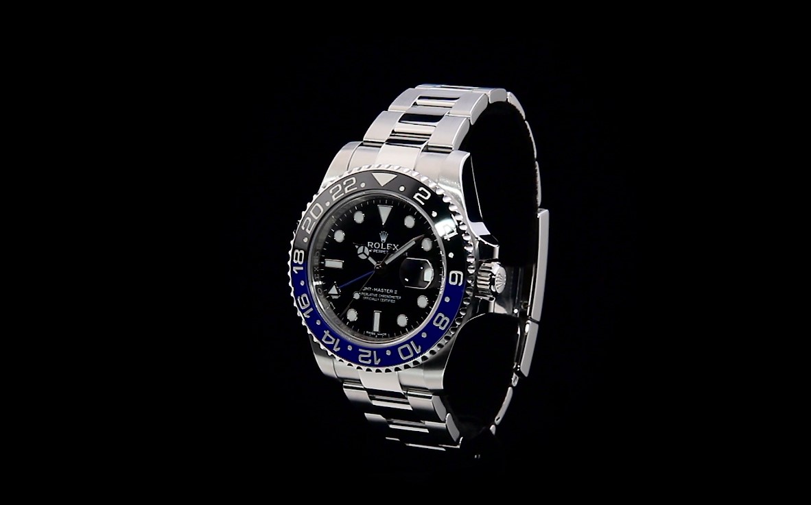 Men's stainless steel Rolex GMT Master II with blue and black bezel.