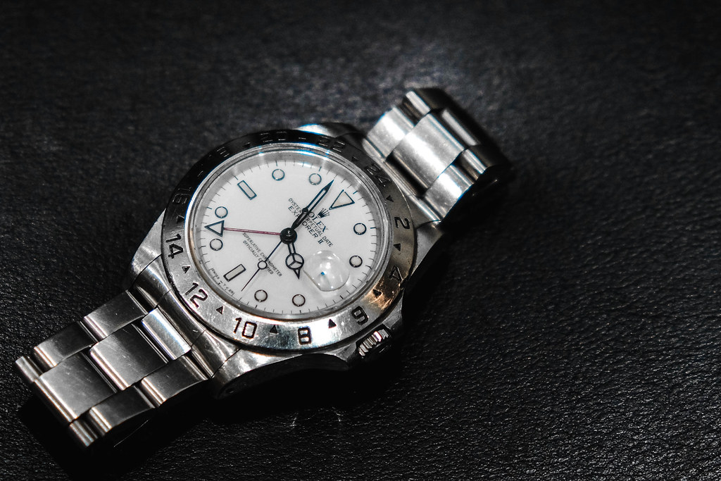 Men's Rolex Explorer II in stainless steel with a white dial.