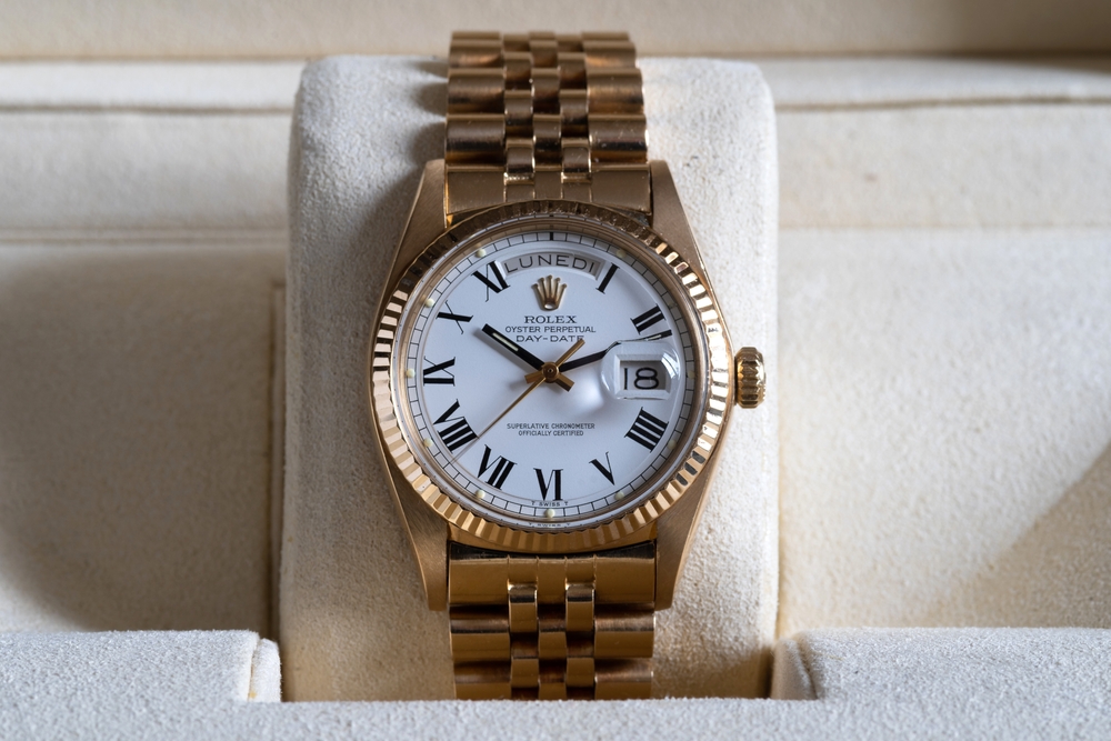 Yellow gold Rolex Day-Date with white Roman numeral dial and Jubilee bracelet.