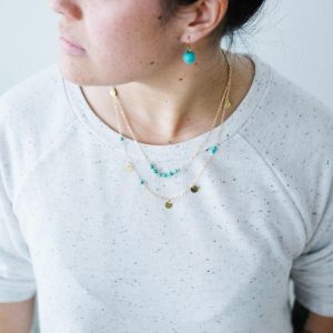 Woman wearing turquoise jewelry.