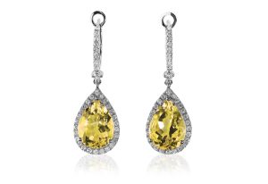 Citrine dangle earrings surrounded by diamond haloes.