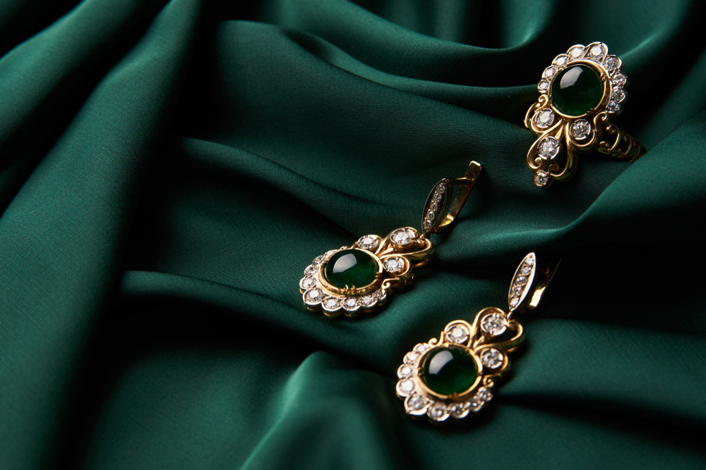 Yellow gold antique ring and earrings set with emeralds and diamonds.