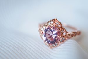 Rose gold filigree engagement ring centered with a pink sapphire.