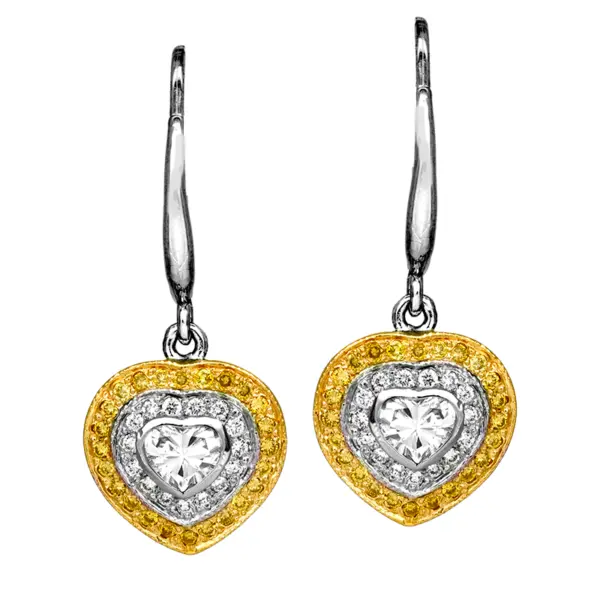 close up of Vintage 14k white & yellow gold drop earrings set with 0.44 carats of heart-cut diamonds surrounded by 0.40 carats of round brilliant diamond double haloes.