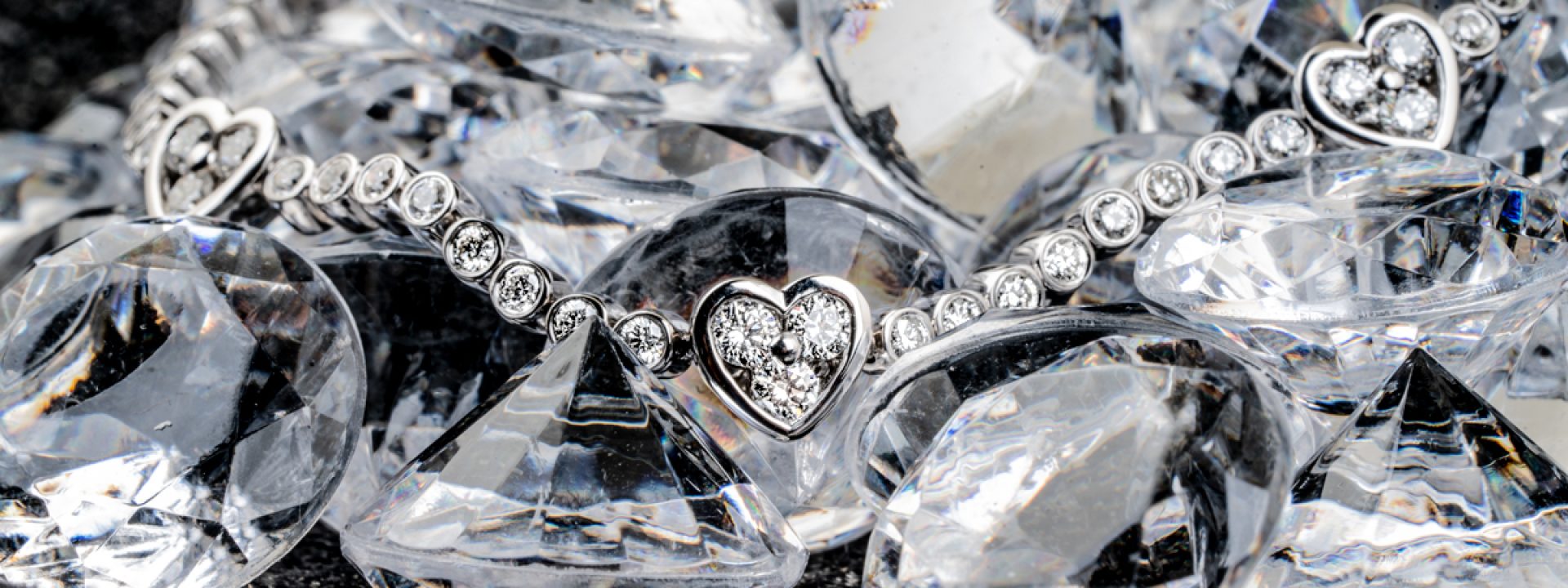 White gold heart station bracelet set with diamonds.