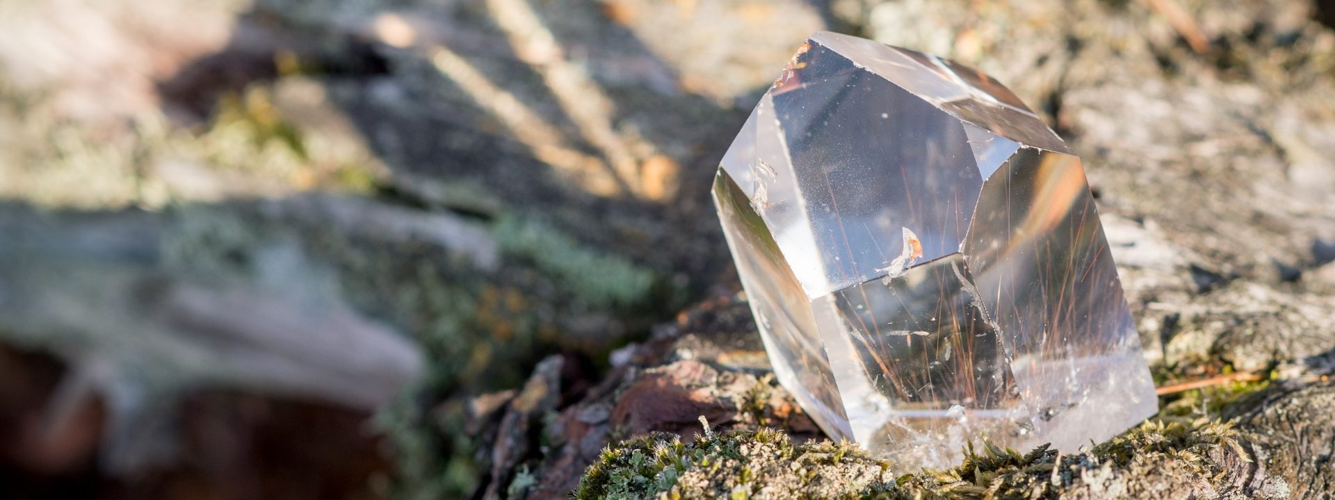 Rough uncut clear gemstone on the beach.