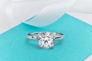 Platinum Tiffany & Co. solitaire engagement ring centered with a diamond.
