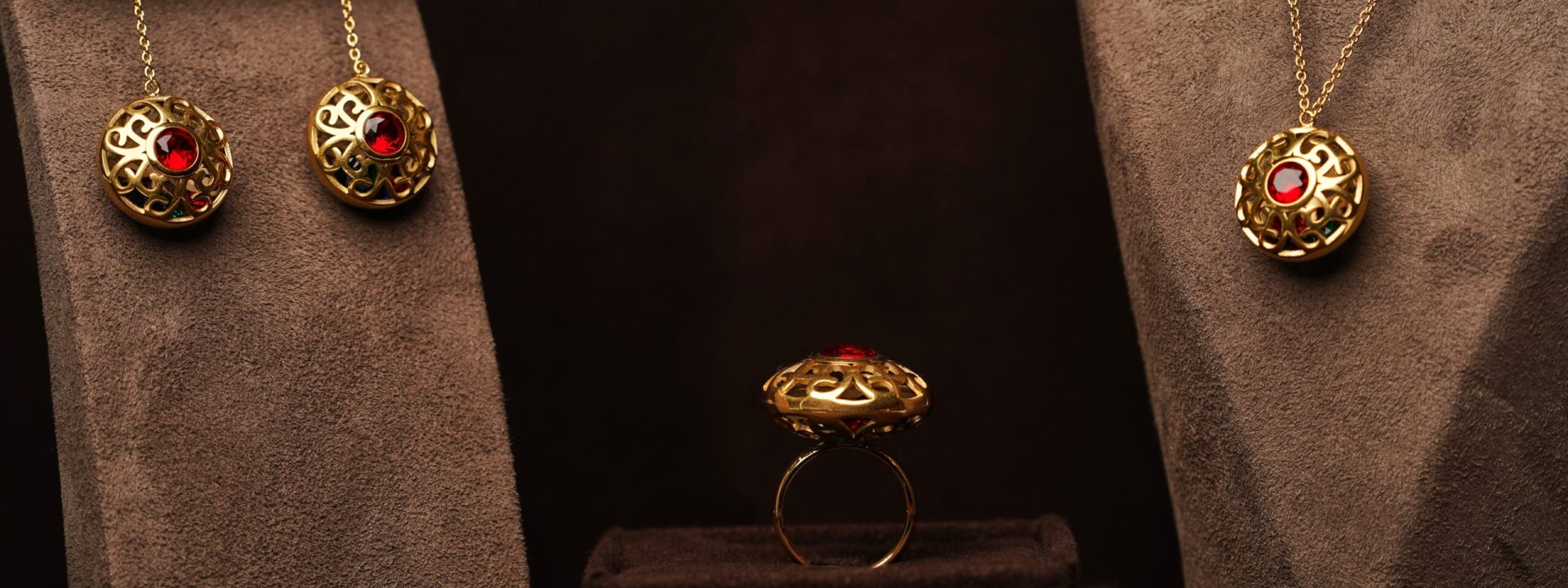 Antique yellow gold filigree earrings, ring, and necklace set with rubies.