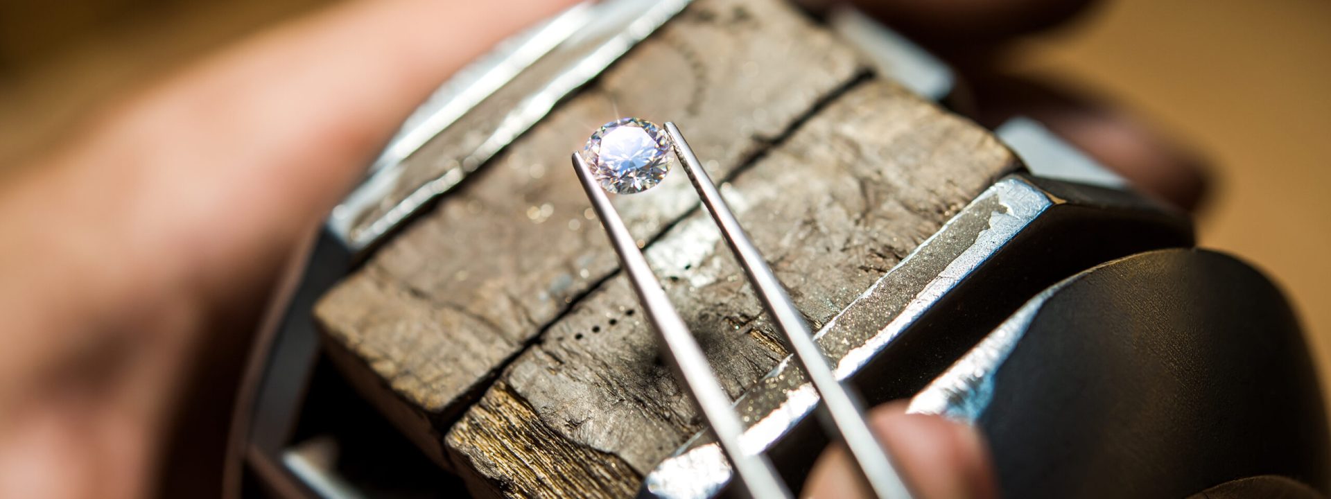 Jeweler Starting Work on Loose Diamond with Tweezers