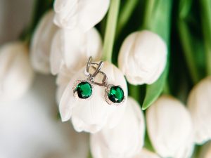 White gold drop earrings set with emeralds.