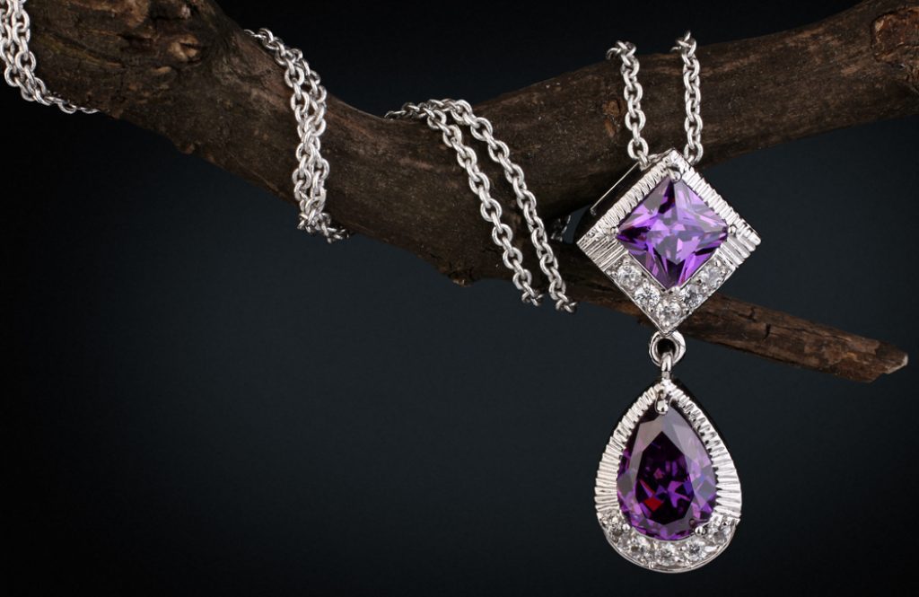 White gold drop necklace set with amethyst wrapped around branch.